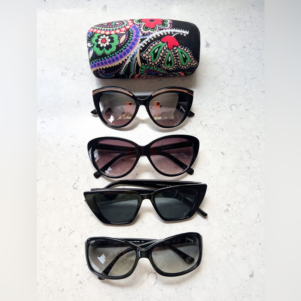 Assortment of designer women’s sunglasses and case.